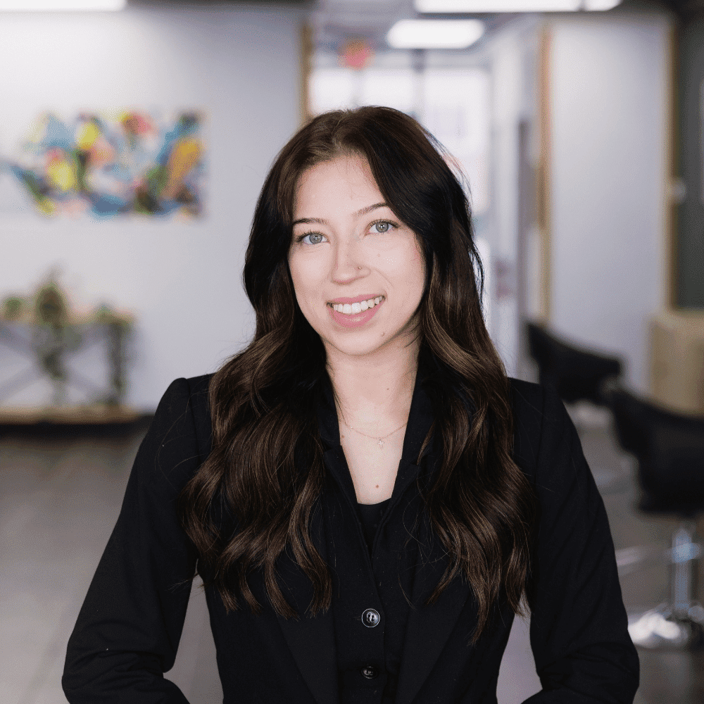 Portrait of Jayda Thrasher, a professional stylist at Frequency Salon, showcasing their expertise and style.