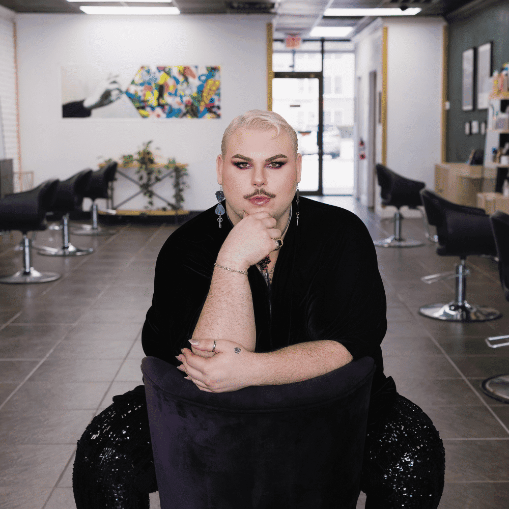 Portrait of Lonnie Novelli-Cole, a professional stylist at Frequency Salon, showcasing their expertise and style.