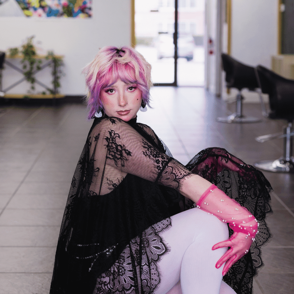 Portrait of Laramie Jane, a professional stylist at Frequency Salon, showcasing their expertise and style.