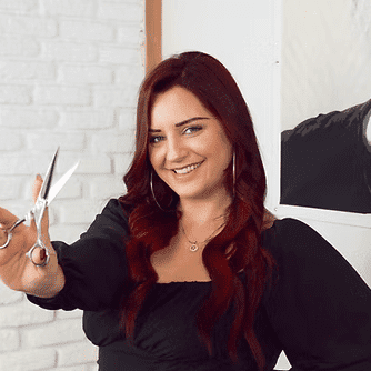 Portrait of Kelsey Armstrong, a professional stylist at Frequency Salon, showcasing their expertise and style.