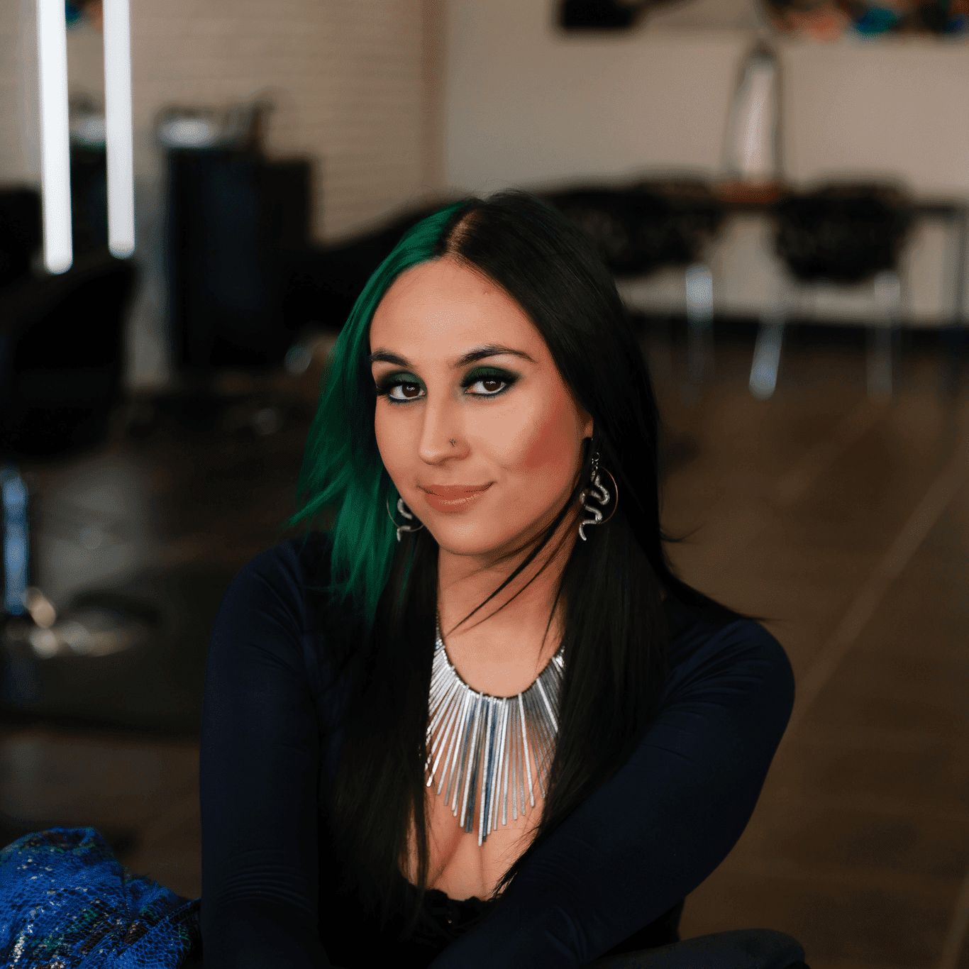 Portrait of Stephanie Morales, a professional stylist at Frequency Salon, showcasing their expertise and style.