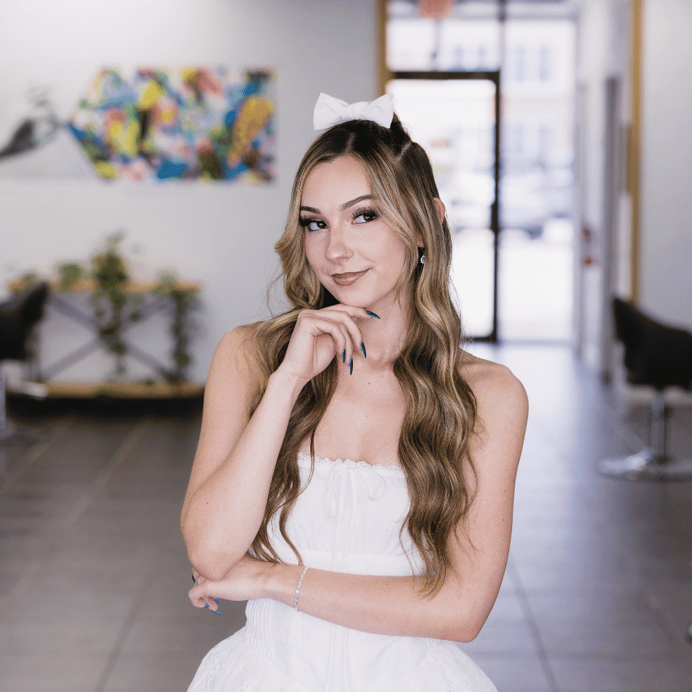 Portrait of Alexis Black, a professional stylist at Frequency Salon, showcasing their expertise and style.