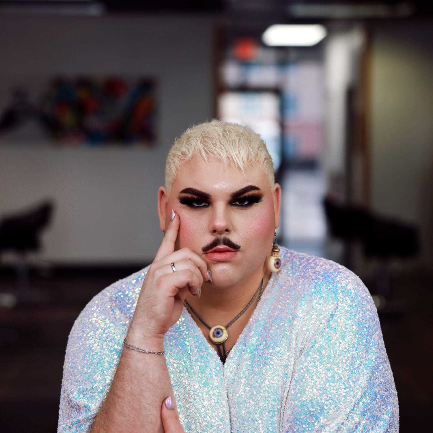 Portrait of Lonnie Novelli-Cole, a professional stylist at Frequency Salon, showcasing their expertise and style.