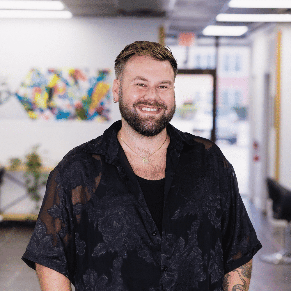 Portrait of Christian Maasoe, a professional stylist at Frequency Salon, showcasing their expertise and style.