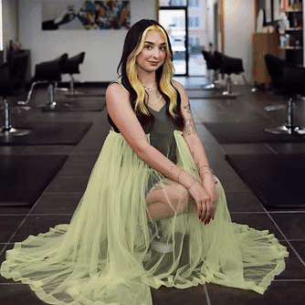 Portrait of Marisa Greenlaw, a professional stylist at Frequency Salon, showcasing their expertise and style.